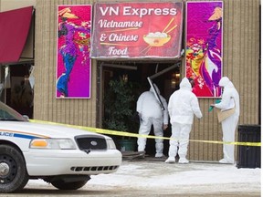 Police forensic unit walks inside VN Express located in downtown Fort Saskatchewan on Dec. 30, 2014.