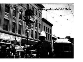 Police officer directing traffic at Jasper Avenue and 101st Street in 1928