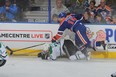 Rough-and-tumble  winger Tyler Pitlick clobbers Alex Goligoski of Dallas Stars in a recent Oilers game.