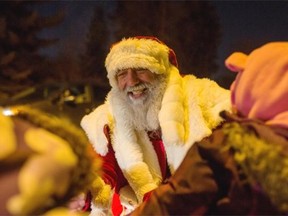 Santa hands out candy canes along Candy Cane Lane in Edmonton on Friday, Dec. 12, 2014.