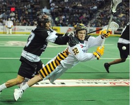 Shayne Jackson shoots on Aaron Bold as the Edmonton Rush play the Minnesota Swarm at Rexall place in Edmonton, January 10, 2015.