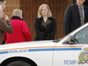 Shelly MacInnis-Wynn, centre, wife of slain RCMP Constable David Matthew Wynn, arrives at St. Albert Alliance Church for a visitation held for family, friends and the general public on Sunday, January 25, 2015.
