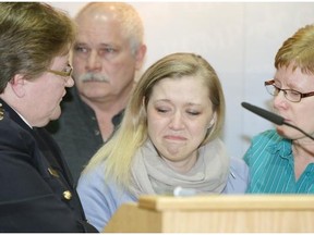 Shelly MacInnis-Wynn, wife of RCMP Const. David Matthew Wynn, appears at a news conference at RCMP K Division in Edmonton on Jan. 19, 2015. Beside her is RCMP Deputy Commissioner Marianne Ryan (left), Duncan MacInnis (rear/Shelly’s uncle) and Dawn Sephton (right/David Wynn’s sister).