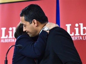 Raj Sherman gets a hug from Alberta Liberal Party president Shelley Wark-Martyn after announcing Monday that he’s resigning as party leader and will not run in the next election.