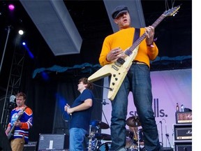 The smalls — bassist Corb Lund, left, singer Mike Caldwel, guitarist Dug Bevans and drummer Terry Johnson (obscured)— perform during the Sonic Boom festival in Edmonton on Sunday, Aug. 31, 2014. The band, formed in 1989, had been on hiatus since 2001, but reunited for a tour this year.