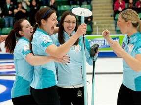 Third Lori Olson-Johns, right, gets ready to join the team celebration with, from left, second Dana Ferguson, lead Rachelle Brown and skip Val Sweeting after winning the Canada Cup women’s final on Dec. 7, 2014, at EnCana Arena in Camrose.