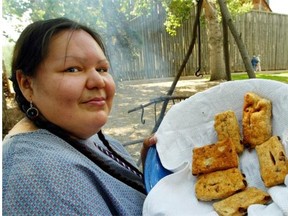 In this Edmonton Journal file photo from 2004, Fort Edmonton interpreter Cheri Fiddler shows off her fried bannock.