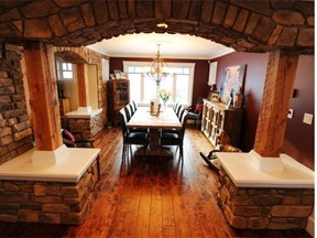This elaborate stone arch -- supported by reclaimed timber columns -- ushers guests into the dining room from the front entrance.