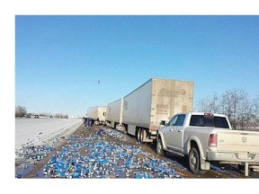 Thousands of cans of Pepsi spilled along the highway after a serious semi crash on the QEII Highway.