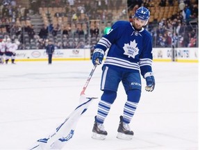 Toronto Maple Leafs forward Nazem Kadri picks up a Maple Leafs jersey on the ice after losing to the Washington Capitals in a National Hockey League at the Air Canada Centre on Jan. 7, 2015.