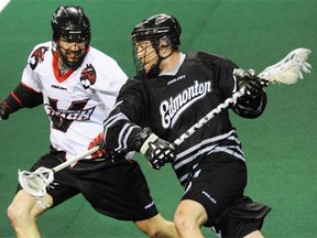 Vancouver Stealth’s Matt Beers tries to stop Edmonton Rush forward Mark Matthews during NLL action in Langley, B.C., on Jan. 25, 2014.