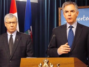Alberta Premier Jim Prentice, right, and Finance Minister Robin Campbell speak during a news conference on Feb. 11, 2015.