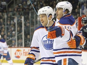Andrew Ference #21 and Nail Yakupov #10 of the Edmonton Oilers celebrate a first period goal against the Winnipeg Jets on Feb. 16, 2015, at the MTS Centre in Winnipeg.