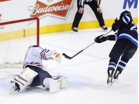 Blake Wheeler of the Winnipeg Jets scores on Edmonton Oilers goaltender Viktor Fasth during the shootout of Monday’s NHL game at the MTS Centre in Winnipeg. Fasth fell awkwardly and had to leave the game.