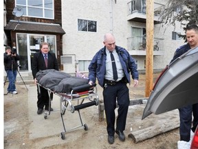 The body of Darby Mahon is removed from an Onoway apartment building in January 2012 after he was shot dead during a confrontation with RCMP.