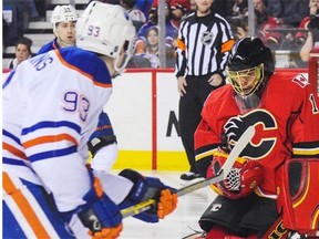 Calgary goalie Jonas Hiller stops a shot by Ryan Nugent-Hopkins of the Edmonton Oilers during NHL action at Calgary’s Scotiabank Saddledome on January 31, 2015. The Flames fought back from a 2-0 deficit to defeat the Oilers 4-2.