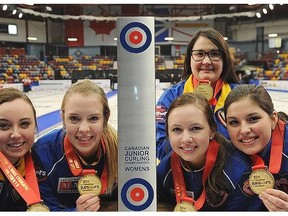 The Canadian junior women’s curling championship team of, from left, skip Kelsey Rocque, third Danielle Schmiemann, second Holly Jamieson, coach Amanda-Dawn Coderre and lead Jessica Iles from Edmonton’s Saville Centre poses with the trophy Saturday at Corner Brook, NL.