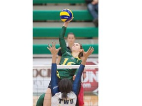 Meg Casault of the University of Alberta Pandas smashes the ball at Nikki Cornwall of the Trinity Western University Spartans during the Canada West Final Four championship final on Friday night at the Saville Community Sports Centre.