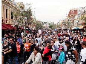 The crowd leave after watching a parade at Disneyland, Thursday, Jan. 22, 2015, in Anaheim, Calif. A major measles outbreak traced to Disneyland has brought criticism down on the small but vocal movement among parents to opt out of vaccinations for their children. (AP Photo/Jae C. Hong)