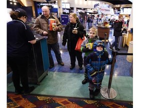 Daryl and Susan Thompson and their sons Charlie, 6, and William, 8, get ready to watch a special screening of the new Sponge Bob movie for families with autistic children at the north side Cineplex Theatres.