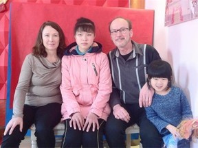 David and Hellen Ream, five-year-old ChenMin, whom they adopted in 2011, and the newest member of the family 14-year-old ZiYe in China on Feb. 9, the day they picked her up from the orphanage.