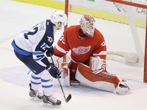 Detroit Red Wings goalie Jimmy Howard looks back to see the puck in the net as Winnipeg right-winger Drew Stafford scores the only goal in the shootout to give the Jets a 5-4 National Hockey League victory on Feb. 14, 2015, at Detroit.