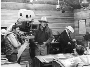 Director Mark Rydel, left and actor John Wayne on the set of the 1972 movie, The Cowboys. Edmonton Journal carrier Timmy Mellott won a contest to fly to Hollywood and meet the Duke and attend the movie première.