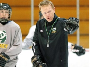 University of Alberta Pandas' head coach Howie Draper (right) gives instruction during team practice at Clare Drake Arena on January 28, 2014.