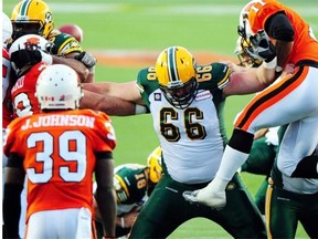 Edmonton Eskimos offensive lineman Matthew O’Donnell (66) stops B.C. Lions players in their tracks in the Canadian Football League pre-season action on June 13, 2014.