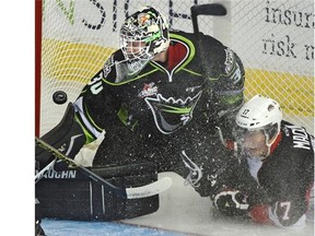 Edmonton Oil Kings goaltender Tristan Jarry still makes the save as Prince George Cougars’ Aaron Macklin knocks the net off its moorings during Monday’s Western Hockey League game at Rexall Place.
