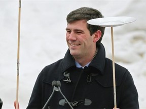 Edmonton Mayor Don Iveson balances two plates on sticks at Churchill Square in Edmonton on January 30, 2015 where Edmontonians and guests from winter cities around the world participated in the city’s first Winter Shake-Up Festival & Market. The event also included Edmonton’s first outdoor market stalls with more than 35 local vendors.