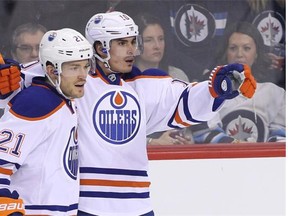 Edmonton Oilers captain Andrew Ference congratulates Nail Yakupov for his goal in the first period of Monday’s NHL game against the Jets at the MTS Centre in Winnipeg.
