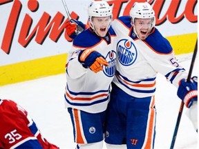 Edmonton Oilers centre Anton Lander, right, celebrates his game-winning overtime goal with teammate Oscar Klefbom during NHL action against the Canadiens in Montreal on Feb. 12, 2015.
