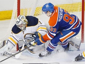 Edmonton Oilers centre Ryan Nugent-Hopkins can’t get his stick on the puck as Buffalo Sabres goalie Jhonas Enroth makes a save during NHL action at Edmonton’s Rexall Place on Jan. 29, 2015.
