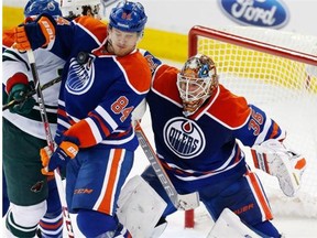 Edmonton Oilers defenceman Oscar Klefbom gets hit with a puck in front of goalie Viktor Fasth during a National Hockey League game against the Minnesota Wild on Jan. 27, 2015, at Rexall Place.