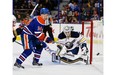 Edmonton Oilers Jordan Eberle (14) chase the puck past Buffalo Sabres goalie Jhonas Enroth (1) during second period NHL action on January 29, 2015.