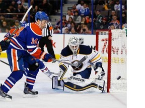 Edmonton Oilers Jordan Eberle (14) chase the puck past Buffalo Sabres goalie Jhonas Enroth (1) during second period NHL action on January 29, 2015.