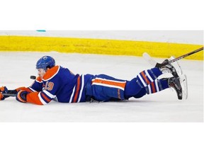 Edmonton Oilers Justin Schultz (19) falls in front of the puck during play in the Buffalo Sabres end on January 29, 2015.