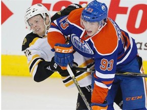 Edmonton Oilers Ryan Nugent-Hopkins (93) and Boston Bruins Carl Soderberg (34) get tangled up during third period NHL action on February 18, 2015 in Edmonton.