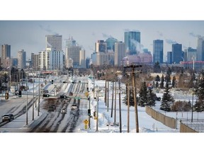 Exhaust rises from the downtown skyline on a cold day in Edmonton on Saturday, Jan. 3, 2015.