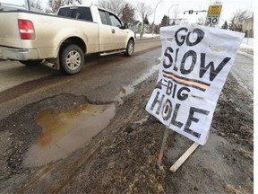 A helpful citizen put up a pothole warning sign along 76th Avenue at 80th Street in Edmonton on Monday, Feb. 23, 2015.