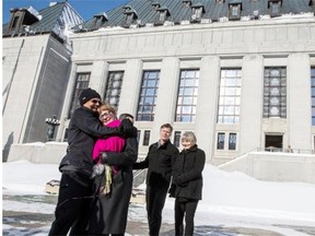 Hollis Johnson and Lee Carter, left, embrace outside the Supreme Court of Canada after winning a historic ruling on Feb. 6, 2015 that struck down the ban doctor-assisted death.