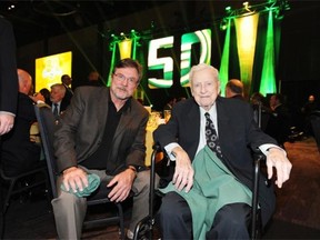 Hugh McColl, right, at the 50th annual Edmonton Eskimos dinner on Oct. 15, 2014. McColl was a member of the Nervous Nine, a group of board of directors that invested their own money in keeping the franchise afloat in the 1960s.
