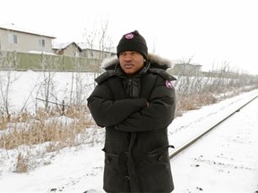 Ishakeem Thomas stands on the train tracks behind his home in northwest Edmonton. Residents in the neighbourhood have been complaining about the noise of the train whistles at all hours of the day.