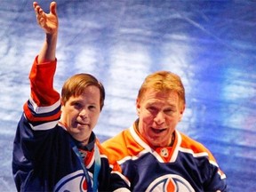 Joey Moss accompanies Rick Hansen to centre ice for a ceremonial faceoff at an Edmonton Oilers’ NHL game at Rexall Place on March 12, 2012.