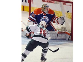 Jordan Schroeder (10) scores on goalie Ben Scrivens (30) as the Edmonton Oilers play the Minnesota Wild at Rexall Place in Edmonton on February 20, 2015.