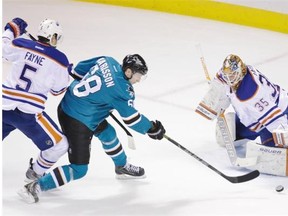 San Jose Sharks right wing Melker Karlsson (68) makes a shot against Edmonton Oilers goalie Viktor Fasth (35) as Oilers defenceman Mark Fayne (5) tries to defend during the first period of their NHL hockey game Monday, Feb. 2, 2015, in San Jose, Calif.