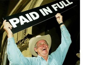 On July 12, 2004, Alberta Premier Ralph Klein held up a paid in full sign after announcing that the province’s debt of $3.7-billion has been paid off in full ahead of schedule. Klein made the announcement following his annual Stampede breakfast at the McDougall Centre in Calgary.