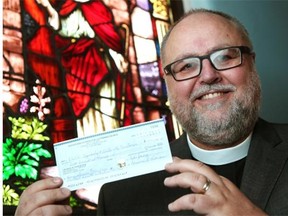 Larry Kochendorfer, Bishop of the Lutheran Synod of Alberta and the Territories, holds a cheque for $200,000 which was received from Augustana Evangelical Lutheran Church for benevolence and mental health awareness initiatives. The church recently sold its downtown property and is using the proceeds of the sale to fund various projects.