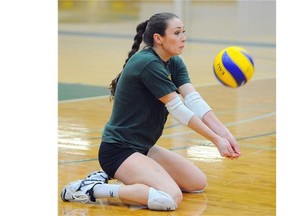 Libero Jessie Niles digs a ball at the University of Alberta Pandas’ volleyball practice at the Saville Centre on Feb. 5, 2015.